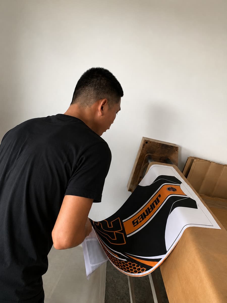 Operator lifting a printed jersey transfer sheet