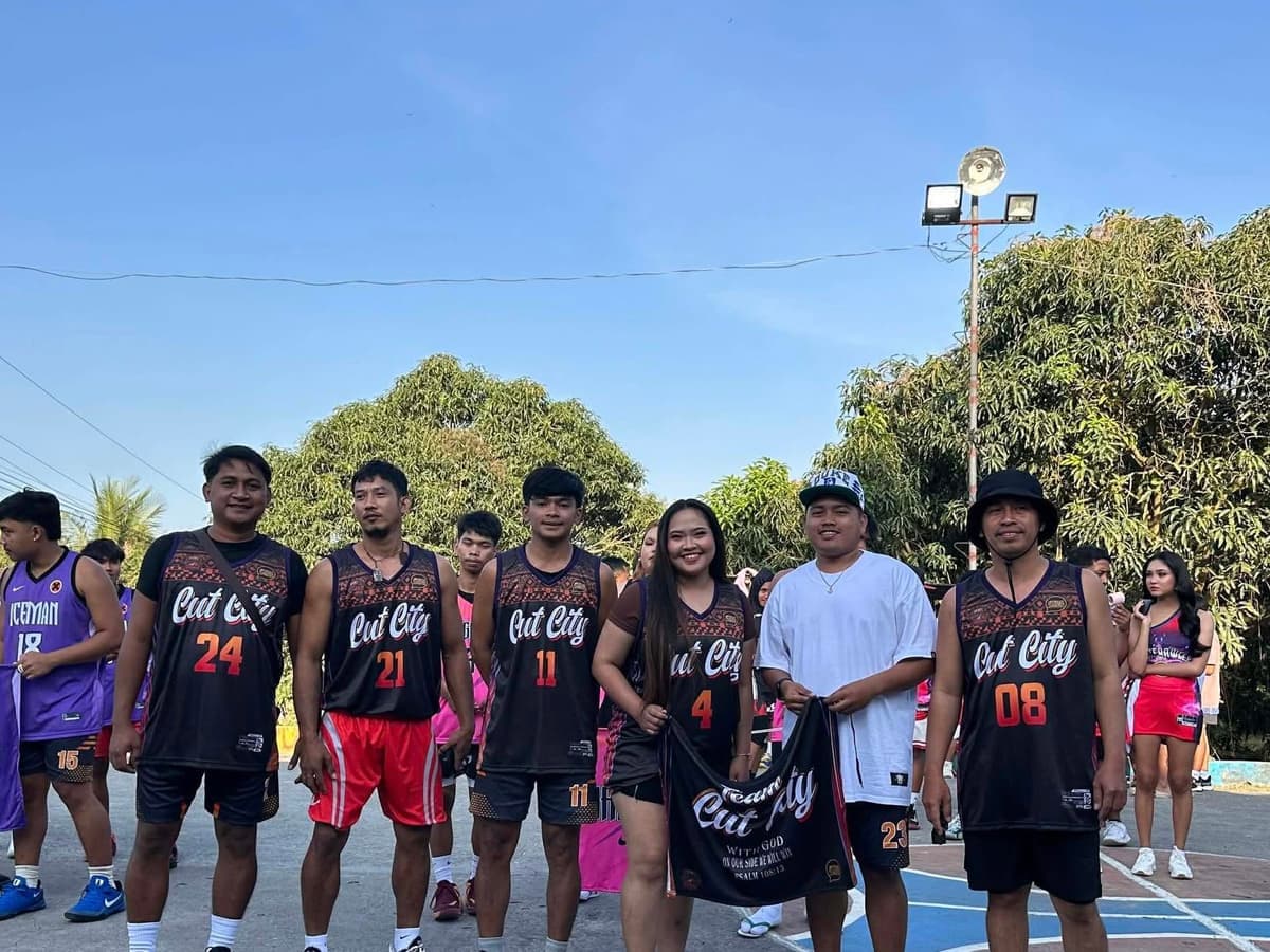 Cut City team in black and orange jerseys on an outdoor court