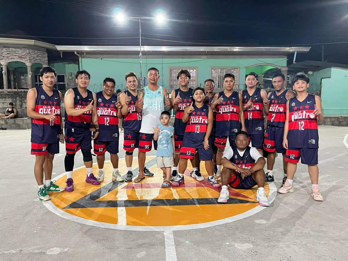 Kalye Quatro basketball team in matching Big Game jerseys on an outdoor court